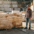Stone mason inspects travertine quarry block